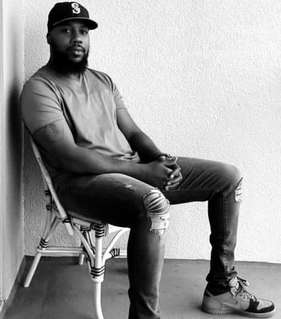 Shawn Vincent, founder of S-DOT Smoke, seated in a black and white portrait